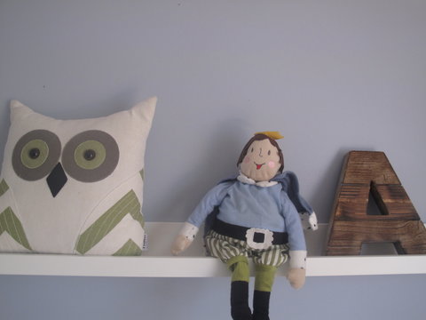 Owl pillow, doll and letter A on a shelf