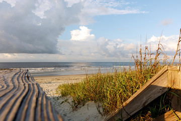 Wooden path through the sand dunes to the Atlantic Ocean beach, Sunset Beach, North Carolina 