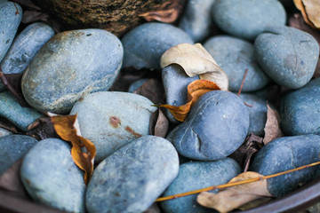 Close up of gray and dark blue smooth river rock. Selective focus