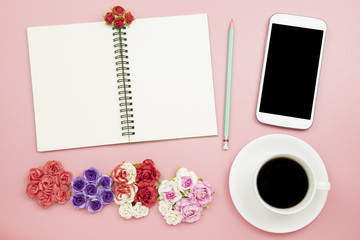 Fototapeta na wymiar Notebook mobile phone black coffee flower rose on pink background pastel style with copyspace flatlay topview.