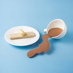 Breakfast / Creative concept photo of plate with bread and cup with splashing coffee made of paper and on blue background.