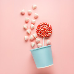 Sweet basket / Creative concept photo of candies in basket on pink background.