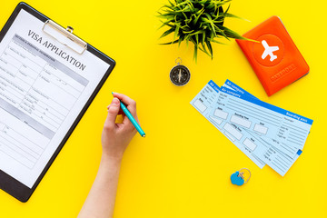 Planning a vacation, planning a trip. Visa application form near passport and airplane ticket on...