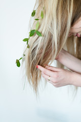 harmony with nature. eco friendly sustainable lifestyle. natural hair products. blond girl wearing flowers in her updo.