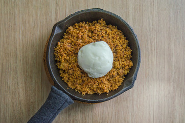 Apple crumble serve with ice cream on the wooden background