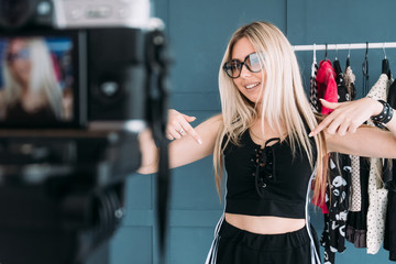 fashion blogger lifestyle and working process. woman telling to push the subscribe button to her...