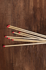 A handful of matches on a dark rustic background with a place for text
