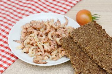 north sea crabs in the bowl  and black bread on wood