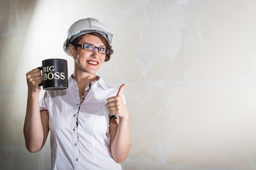 Cute young woman in white construction protection building helmet in unfinished apartment © keleny
