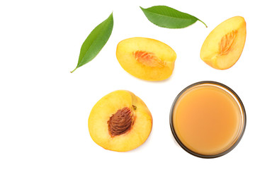 glass of peach juice with peach fruit, green leaf and slices isolated on white background. top view