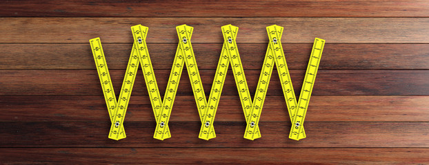 Yellow folding wooden ruler isolated cutout on wooden background, banner. 3d illustration
