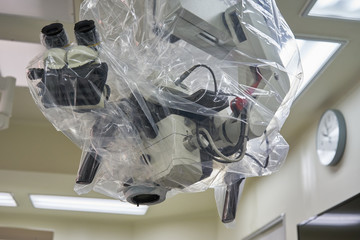 A draped surgical microscope in operating room