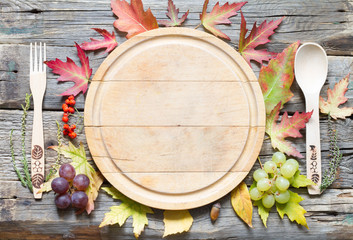 Autumn leaves and empty cutting board food fall background concept
