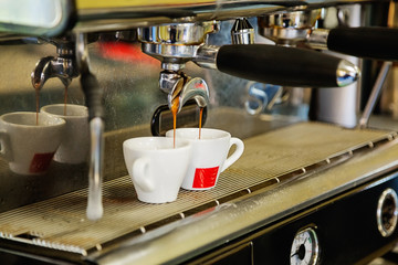 Close-up of espresso pouring from coffee machine.