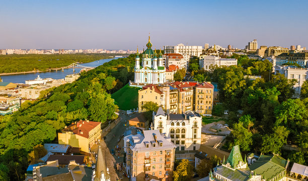 Aerial top view of Saint Andrew's church and Andreevska street from above, cityscape of Podol district on sunset, skyline of city of Kiev (Kyiv), Ukraine
