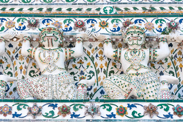 Closeup of warrior statues carved in stone in Wat Arun