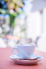 blurred background of espresso on the table in the garden