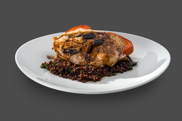 roasted chicken steak garnished with sauces and salad on a plate