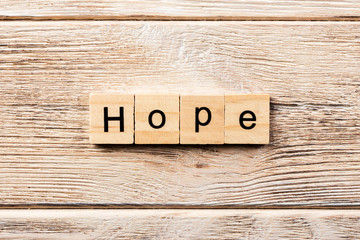 hope word written on wood block. hope text on table, concept