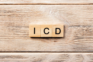 icd word written on wood block. icd text on table, concept