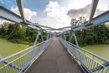 Obraz premium iron steel frame construction of pedestrian bridge across the river