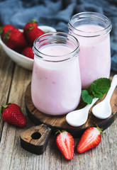 Jars with strawberry yogurt