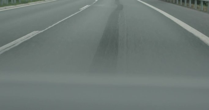 4k camera moving above asphalt road close up low angle view fast speed car overtaking macro shot. Aerial flight on empty two-lane highway detail. Traffic auto transportation logistics concept