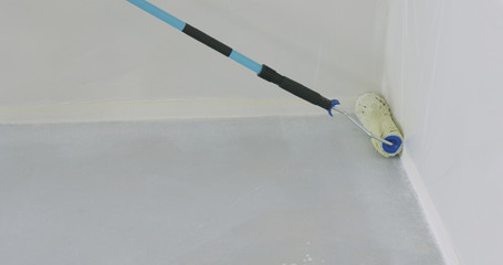 closeup applying primer on the floor