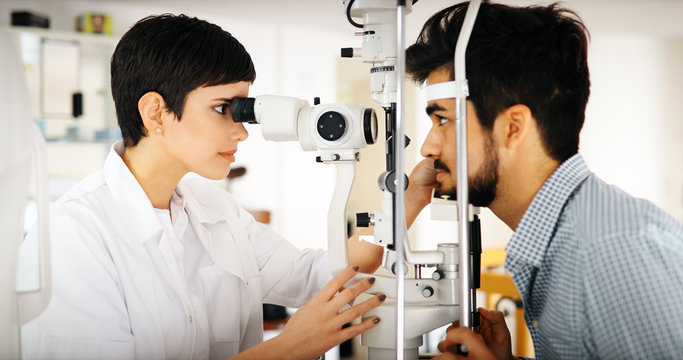 Optometrist Examining Patient In Modern Ophthalmology Clinic