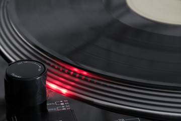 Spinning vinyl record with light from stroboscope on turntable