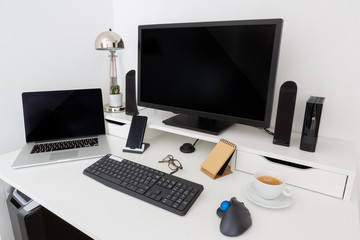 Computer and devices on modern white desk interior 3D rendering