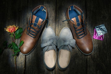 Male and female shoes.Flower and condom.Lovers
