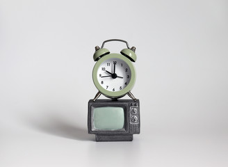 An alarm clock on a miniature television.