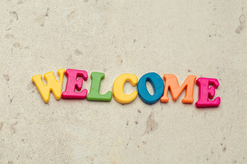 Word Welcome written in colorful plastic letters close up shot