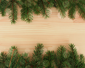 Fir branches on a wooden background