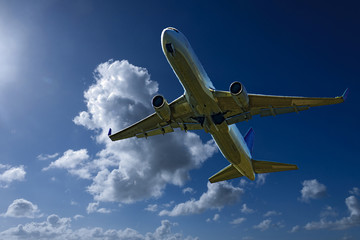 Aircraft in flight with Cumulonimbus cloud in blue sky. Australia.