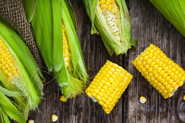 Ripe corn on a wooden table.