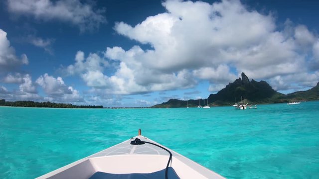 Sailing around blue lagoon and Otemanu mountain at Bora Bora island, Tahiti, French Polynesia (view from action camera)
