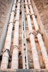 Fototapeta premium Water pipeline near footpath in the city.