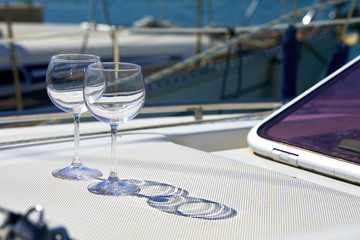 Pair of wineglasses against the yacht