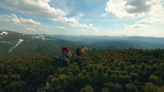 a group of tourists walks the mountains