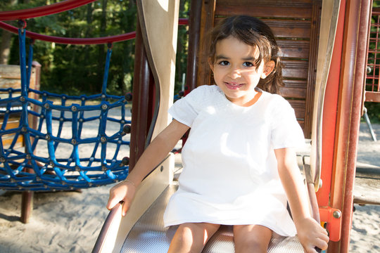 Beauty Child Girl Play In Children Area Playground In Park