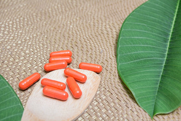 Herbal medicine in red capsules