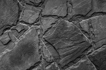 Black and white photo of row stones wall texture, background.