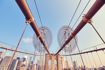 Brooklyn Bridge at sunrise, vintage stylized picture, New York City, USA.