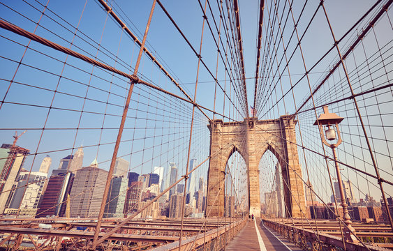 Brooklyn Bridge at sunrise, vintage stylized picture, New York City, USA.