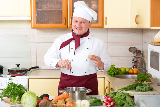 Chef at home in the kitchen to cook a delicious dish of vegetables.