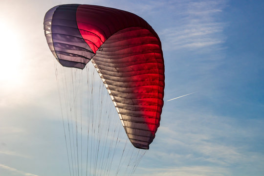 The wing of a paraglider in flight in the air
