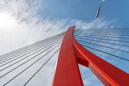 Red Cable Bridge Against Blue Sky