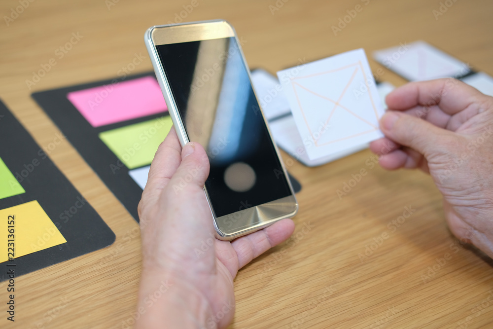 Wall mural user experience, ux designer designing web on smartphone layout. ui planning mobile application. dev